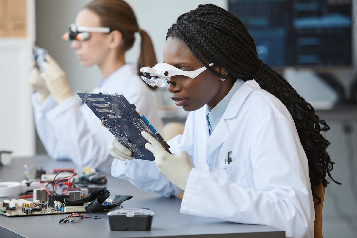 African American technician inspecting equipment